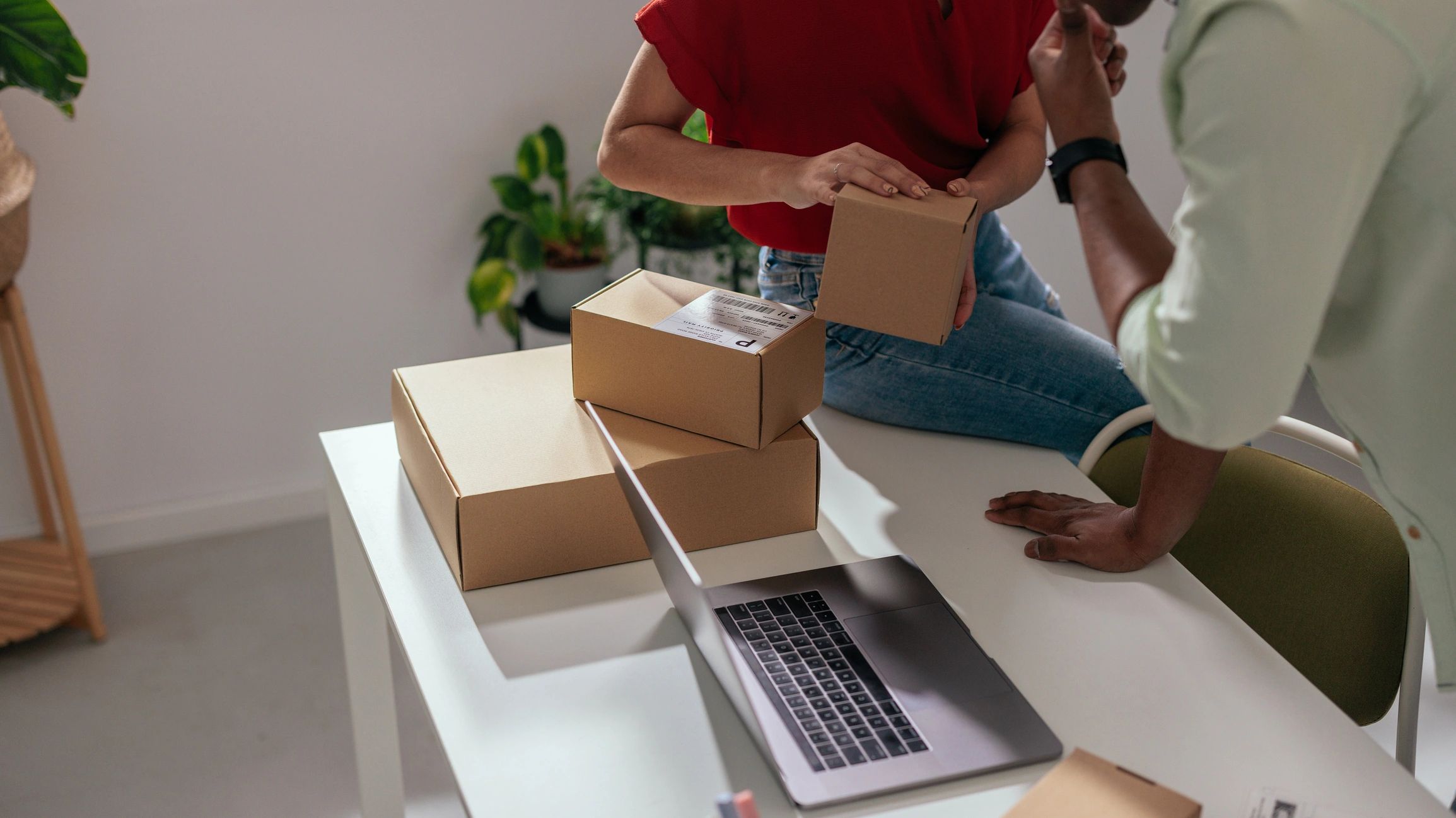 Team packing products into shipping boxes at a small business packing station