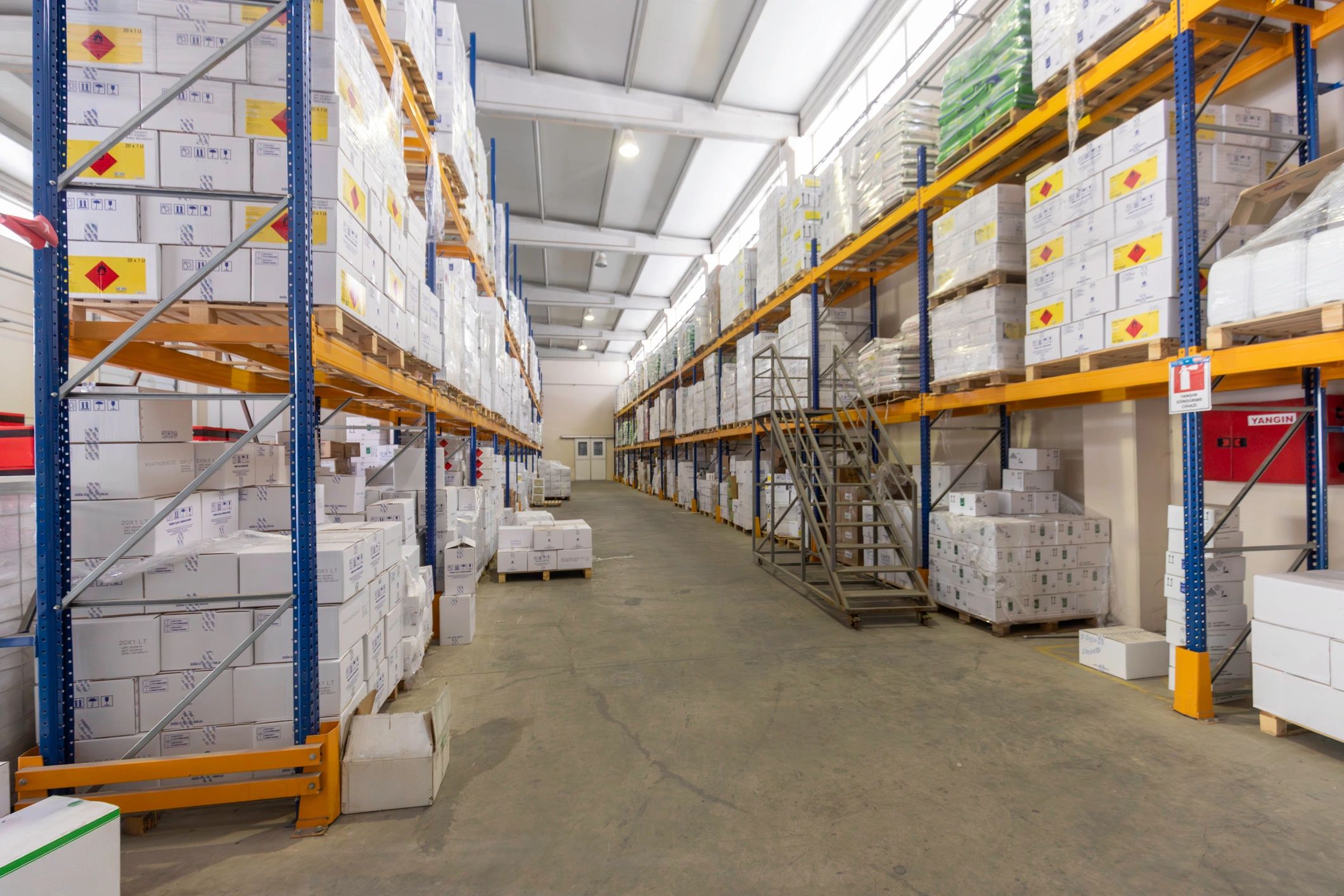 Organized warehouse aisle with stacked boxes