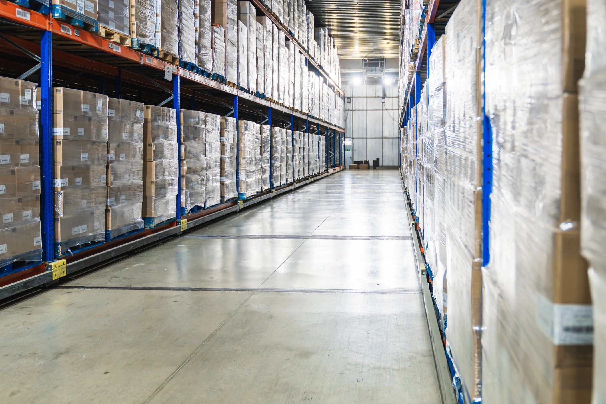 Pallets of boxed goods in a logistics warehouse representing big-box scale