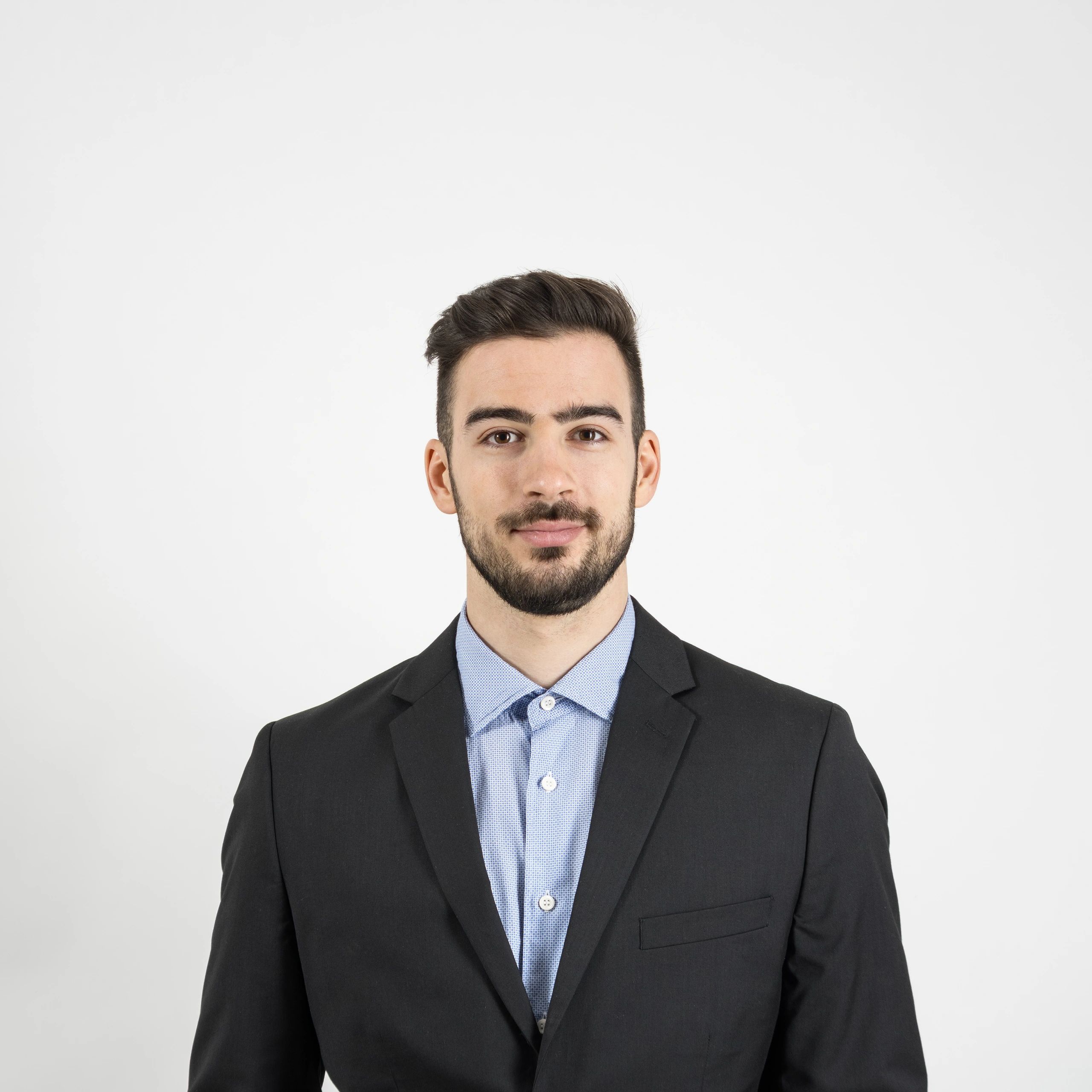 Professional headshot of a man in a suit on neutral background